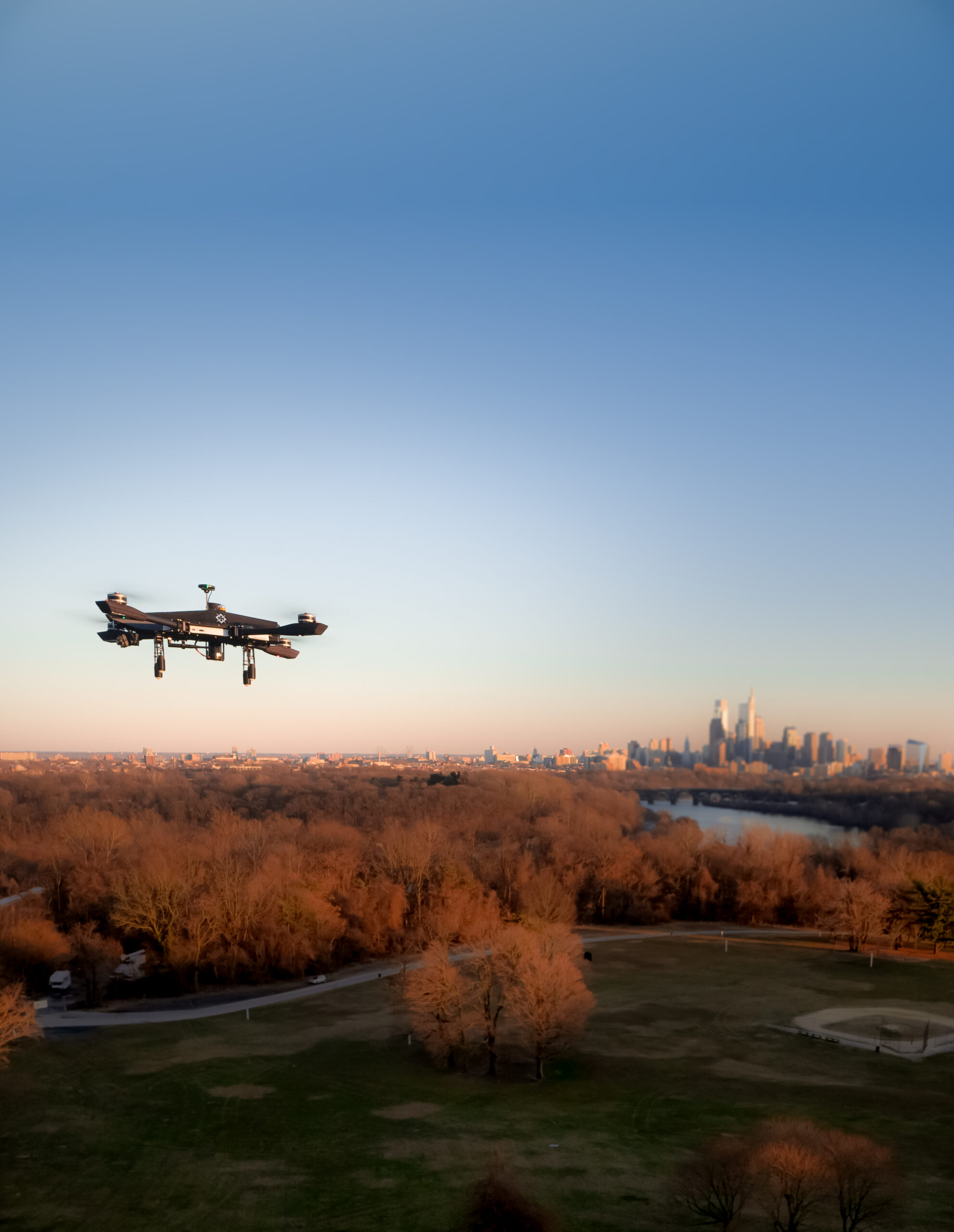 Asylon secutiy drone flies and observes the horizon of a city.