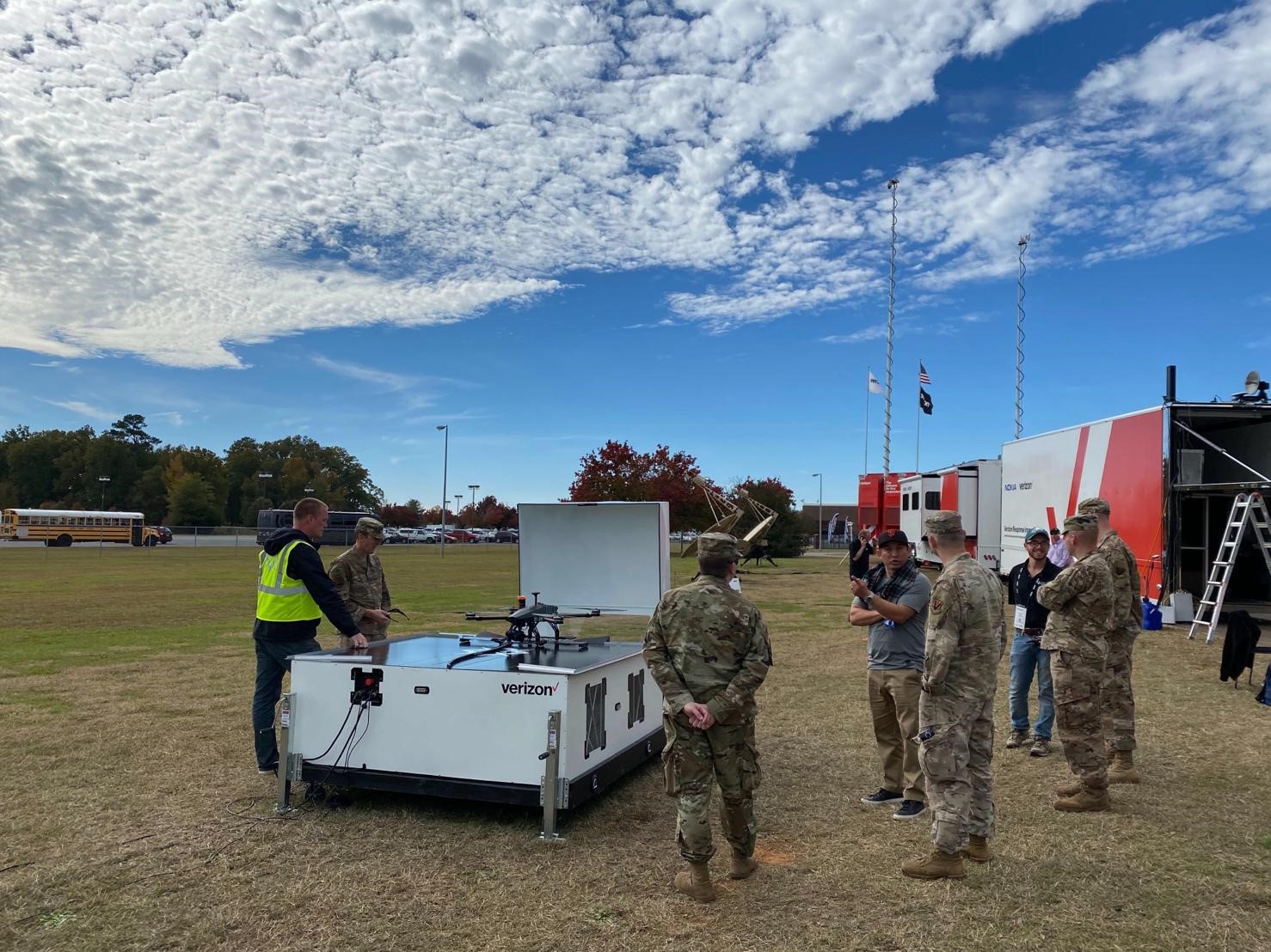 Military personnel prepares an Asylon security drone for takeoff.