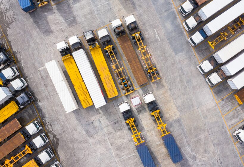 High-angle aerial view of a trucking depot or shipping yard