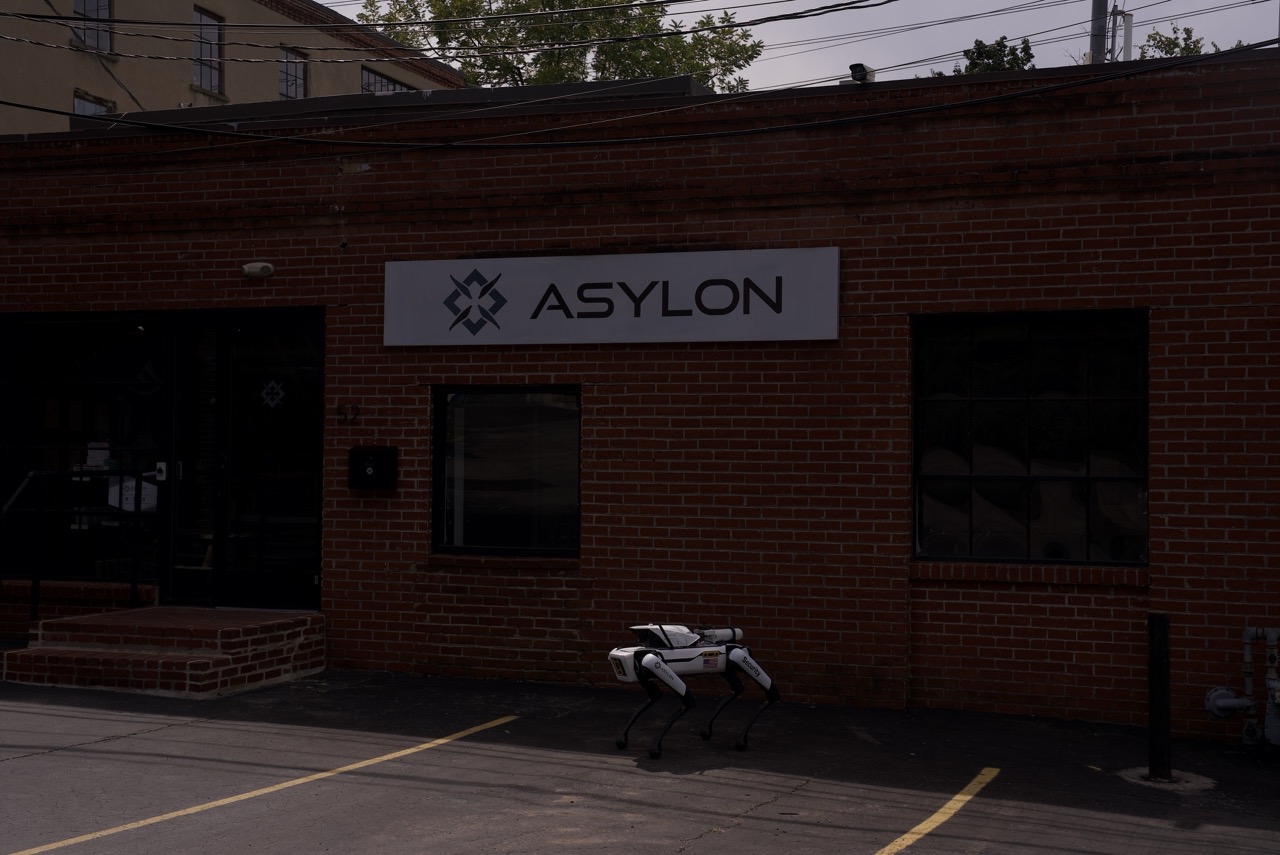 Asylon DroneDog robot security guard stands outside Asylon headquarters, keeping property perimeter secure.