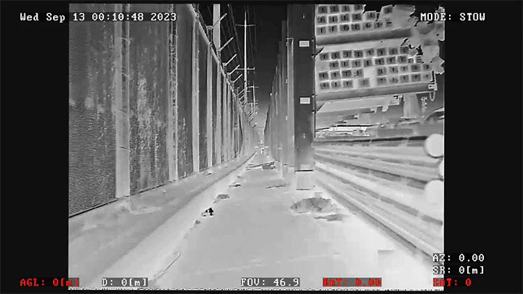 Thermal aerial surveillance from a perimeter security drone patrolling a high-security industrial fence line for CTPAT compliance.