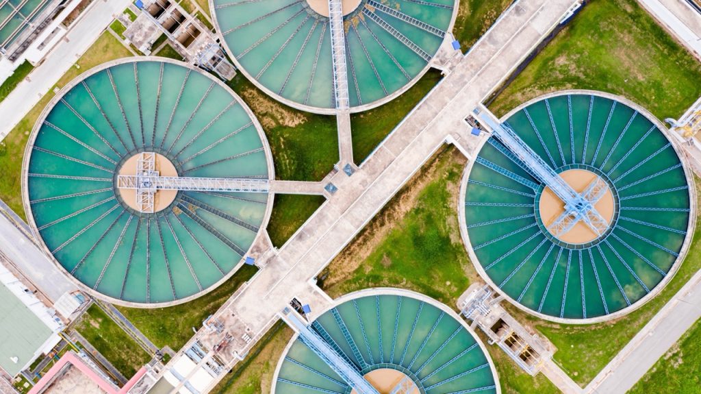 Aerial downward view of a water treatment plant with long perimeter and many sections