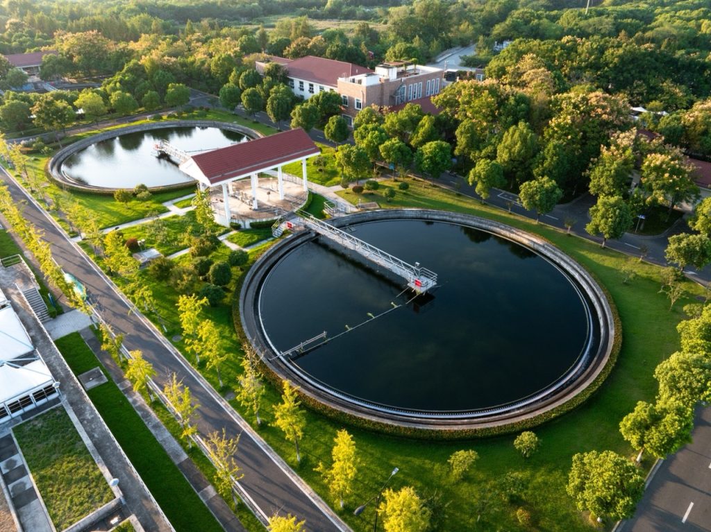 Aerial view of a water treatment facility plant among a suburban landscape.