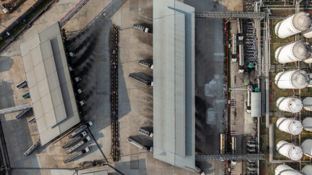 Aerial overhead view of industrial oil storage tank farm and distribution terminal.