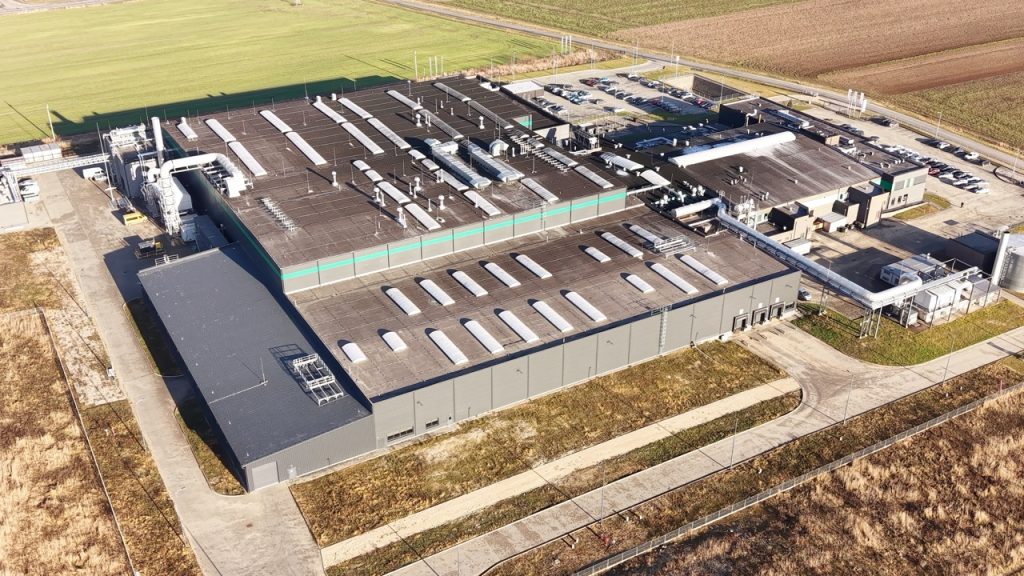Aerial view of large data center campus with utility infrastructure, parking, and surrounding perimeter roads.